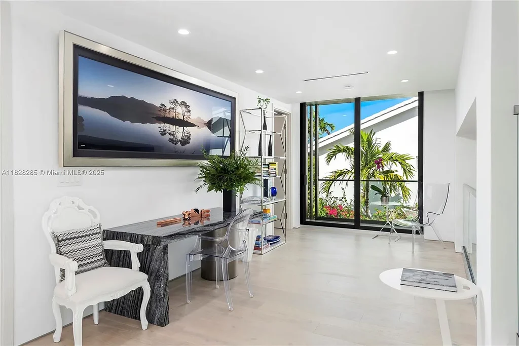 Modern waterfront home at 1410 S Biscayne Point Rd featuring limestone façade, private saltwater pool, and 75 feet of bay frontage in Miami Beach.