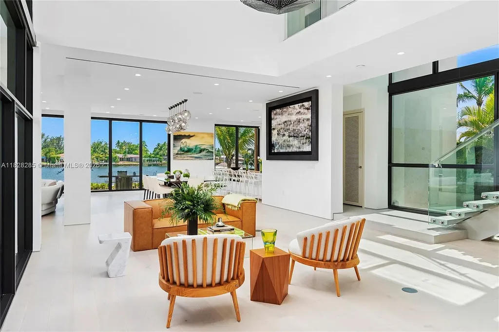 Modern waterfront home at 1410 S Biscayne Point Rd featuring limestone façade, private saltwater pool, and 75 feet of bay frontage in Miami Beach.