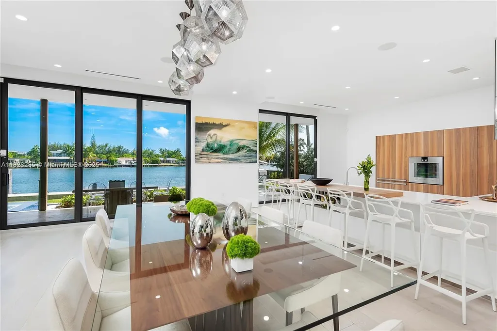 Modern waterfront home at 1410 S Biscayne Point Rd featuring limestone façade, private saltwater pool, and 75 feet of bay frontage in Miami Beach.