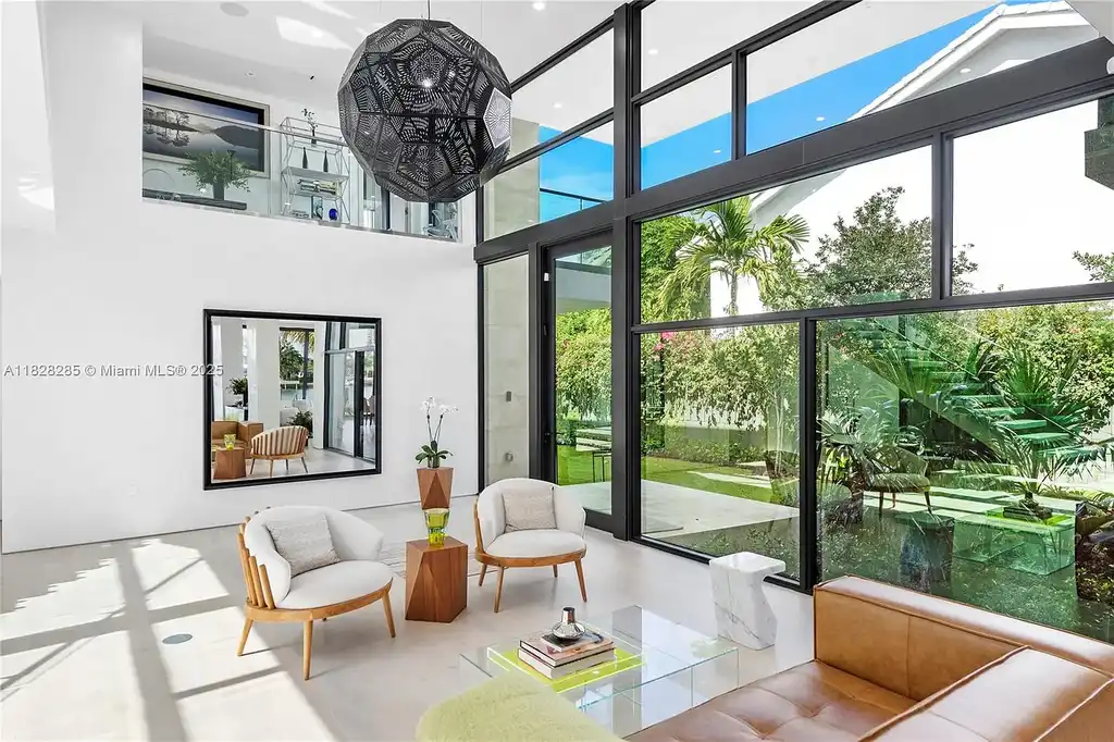 Modern waterfront home at 1410 S Biscayne Point Rd featuring limestone façade, private saltwater pool, and 75 feet of bay frontage in Miami Beach.