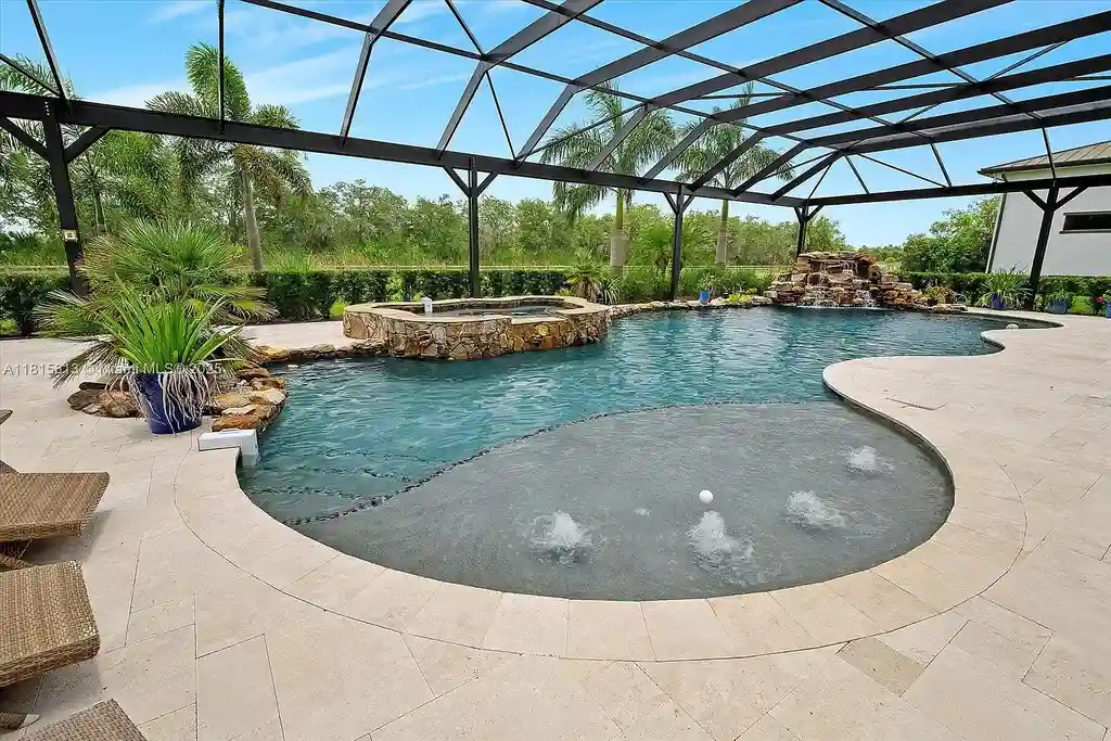 Aerial view of 16675 C24 Canal Rd featuring pool, stables, and 200+ acres of equestrian and hunting land in Port Saint Lucie