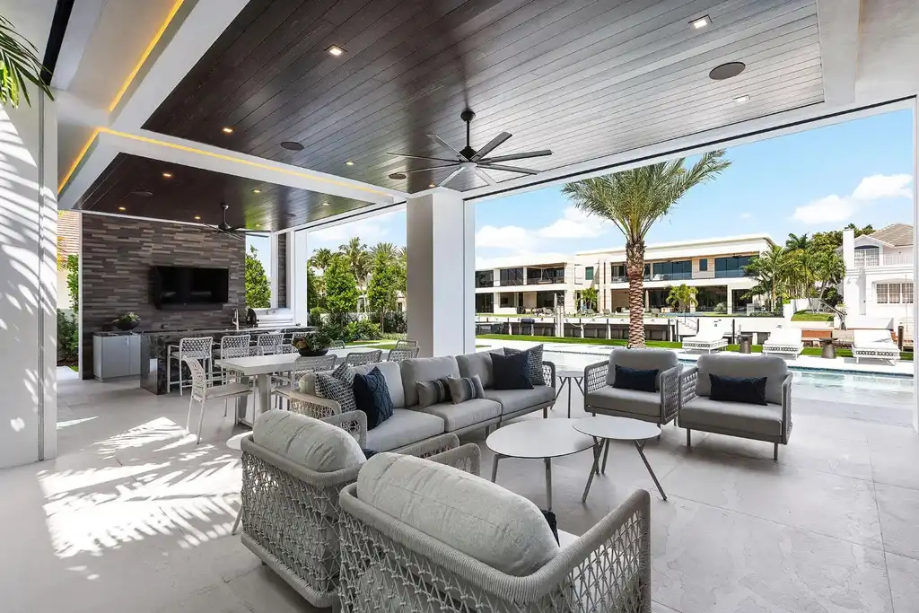 Exterior view of 169 W Coconut Palm Road, Boca Raton, featuring smart home design, resort-style pool, and canal frontage in Royal Palm Yacht & Country Club