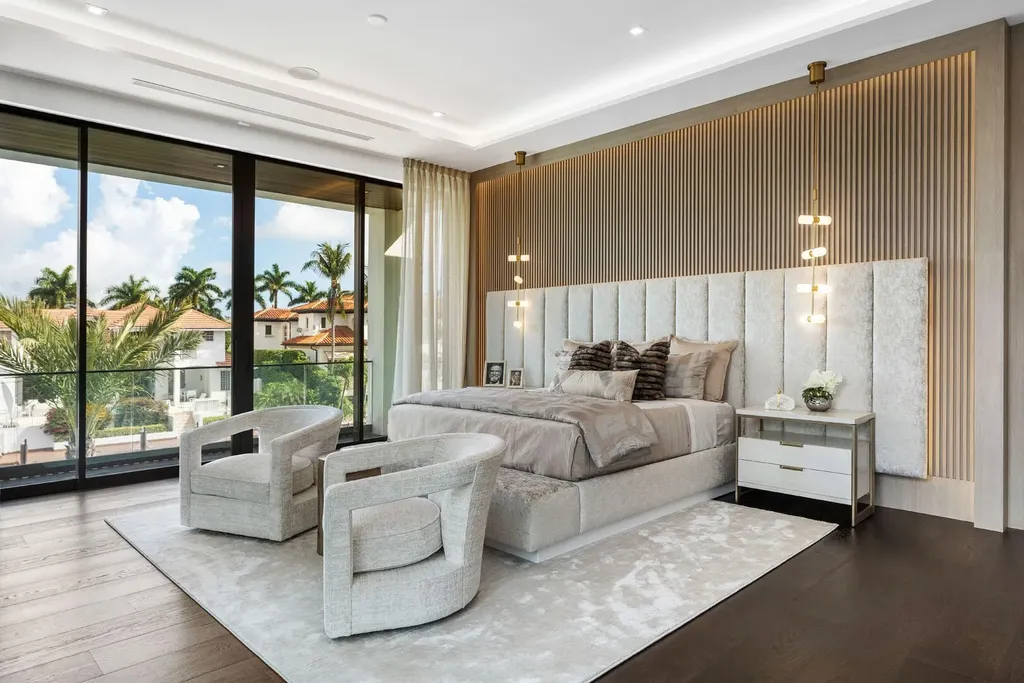 Exterior view of 169 W Coconut Palm Road, Boca Raton, featuring smart home design, resort-style pool, and canal frontage in Royal Palm Yacht & Country Club