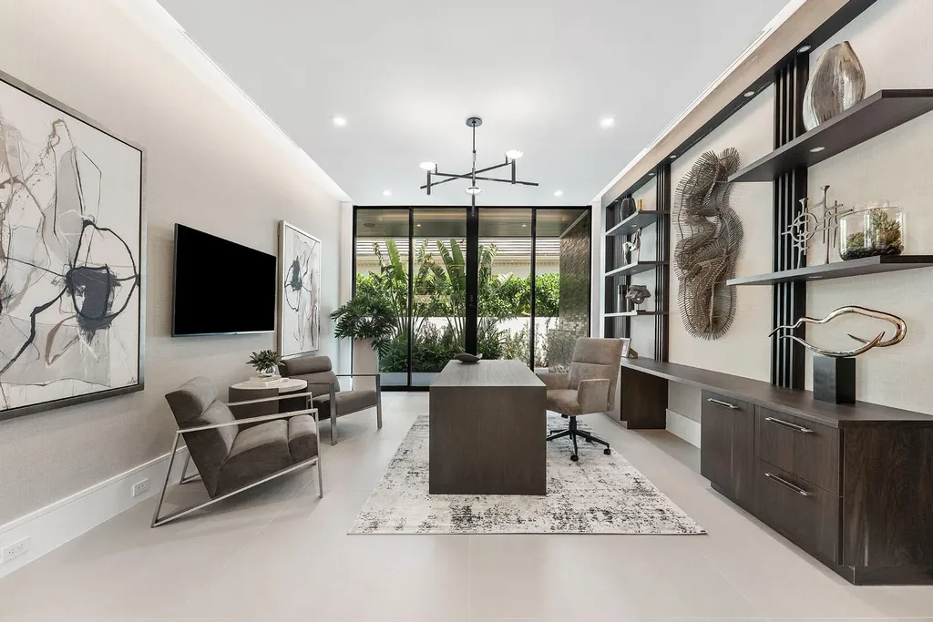 Exterior view of 169 W Coconut Palm Road, Boca Raton, featuring smart home design, resort-style pool, and canal frontage in Royal Palm Yacht & Country Club