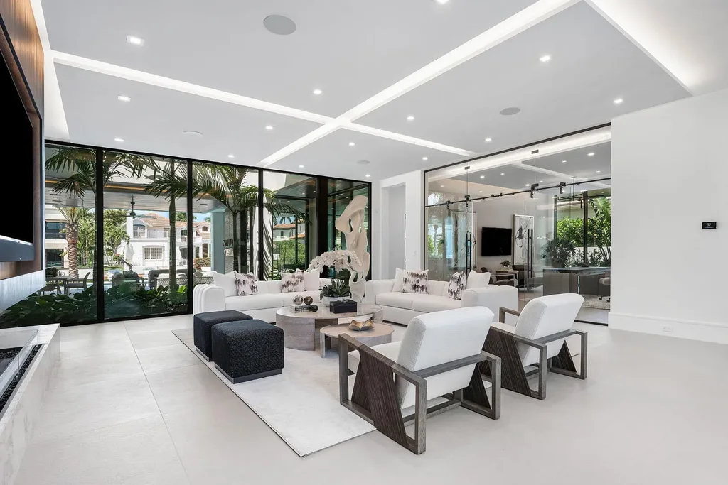 Exterior view of 169 W Coconut Palm Road, Boca Raton, featuring smart home design, resort-style pool, and canal frontage in Royal Palm Yacht & Country Club