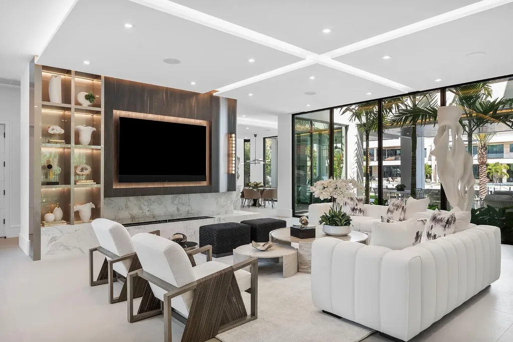 Exterior view of 169 W Coconut Palm Road, Boca Raton, featuring smart home design, resort-style pool, and canal frontage in Royal Palm Yacht & Country Club
