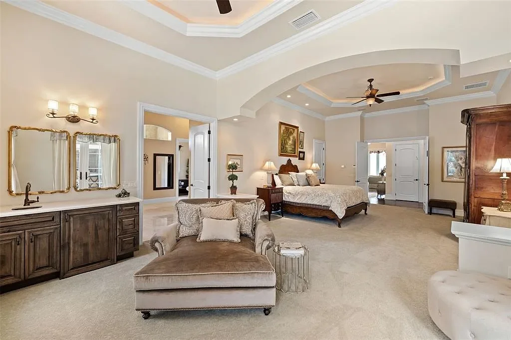 Lakefront luxury estate at 18521 Wayne Rd in Odessa FL featuring a resort-style saltwater pool, grand circular driveway, and manicured 4.75-acre grounds
