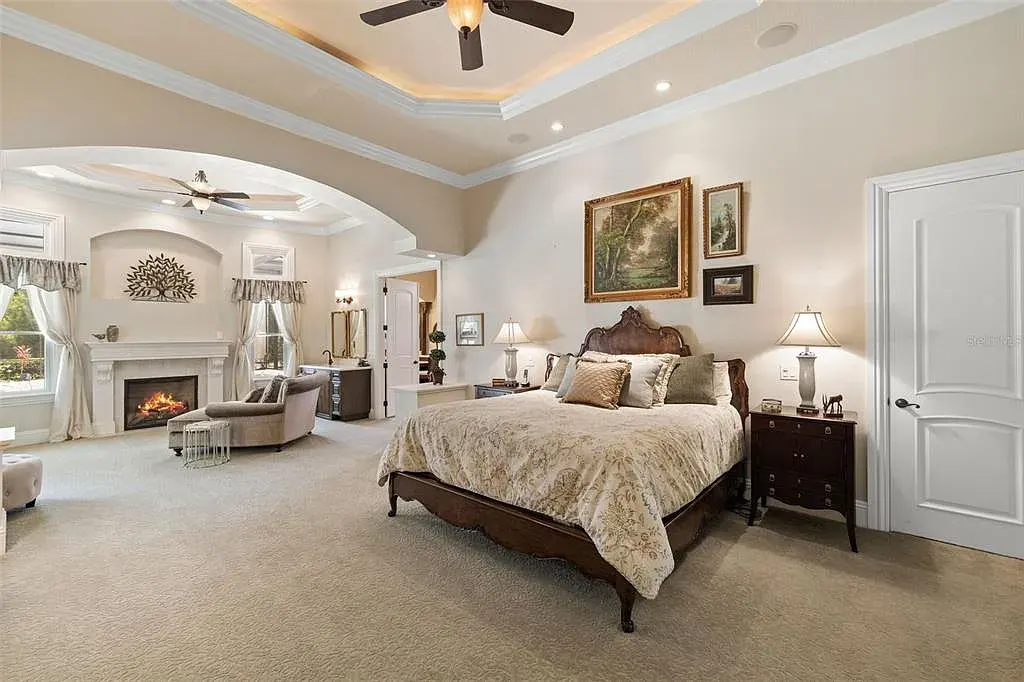 Lakefront luxury estate at 18521 Wayne Rd in Odessa FL featuring a resort-style saltwater pool, grand circular driveway, and manicured 4.75-acre grounds
