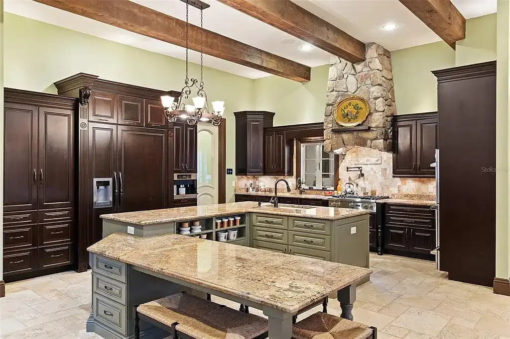 Lakefront luxury estate at 18521 Wayne Rd in Odessa FL featuring a resort-style saltwater pool, grand circular driveway, and manicured 4.75-acre grounds