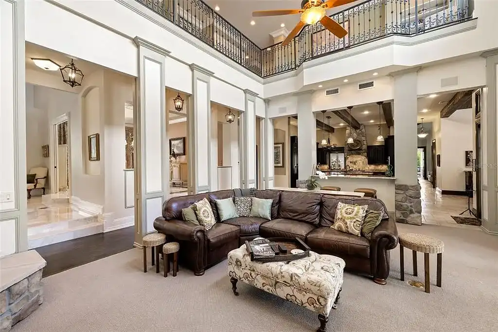 Lakefront luxury estate at 18521 Wayne Rd in Odessa FL featuring a resort-style saltwater pool, grand circular driveway, and manicured 4.75-acre grounds