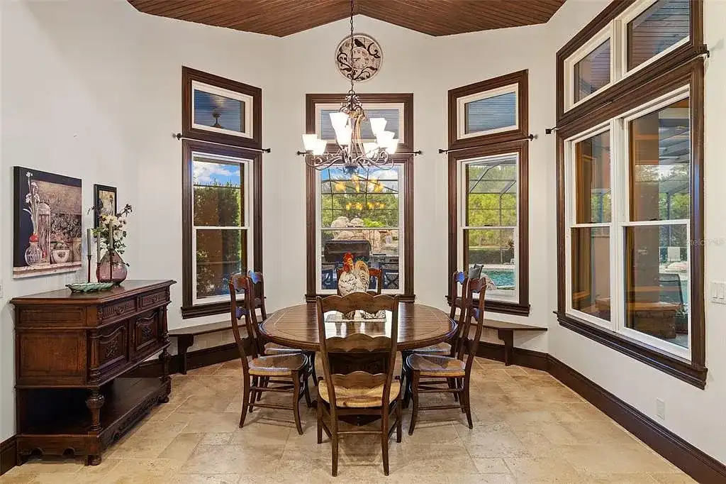 Lakefront luxury estate at 18521 Wayne Rd in Odessa FL featuring a resort-style saltwater pool, grand circular driveway, and manicured 4.75-acre grounds