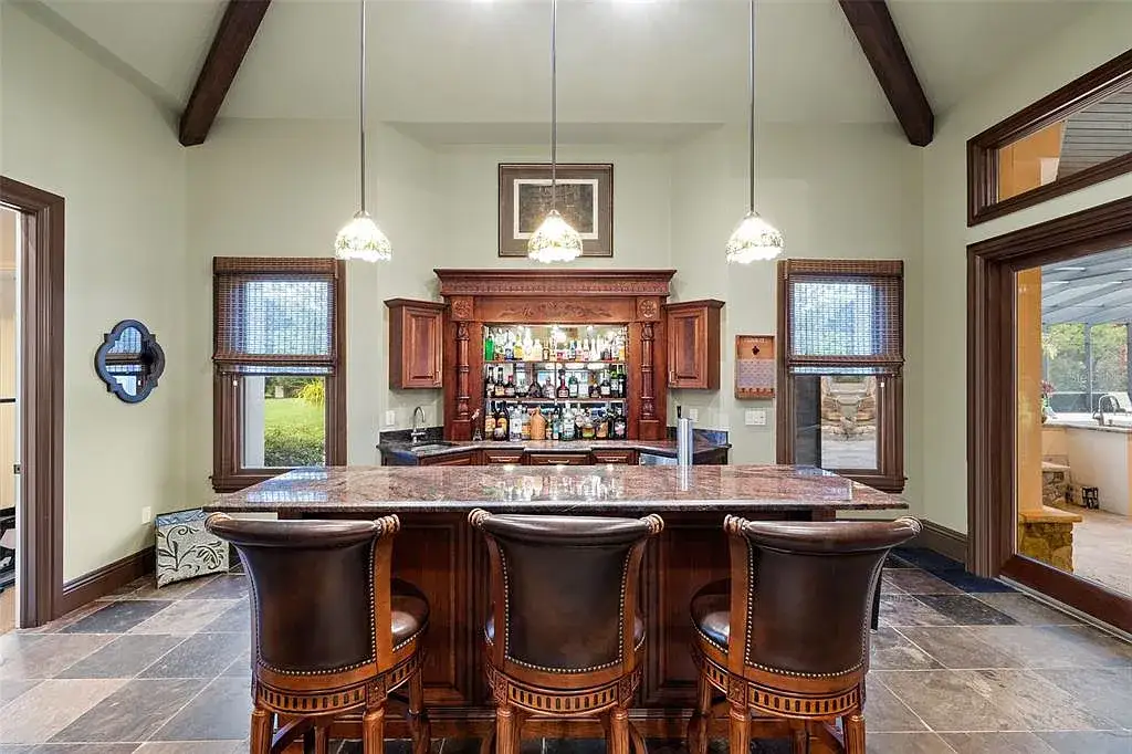 Lakefront luxury estate at 18521 Wayne Rd in Odessa FL featuring a resort-style saltwater pool, grand circular driveway, and manicured 4.75-acre grounds