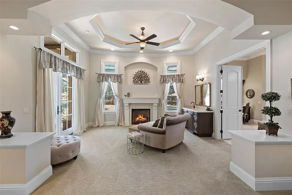 Lakefront luxury estate at 18521 Wayne Rd in Odessa FL featuring a resort-style saltwater pool, grand circular driveway, and manicured 4.75-acre grounds