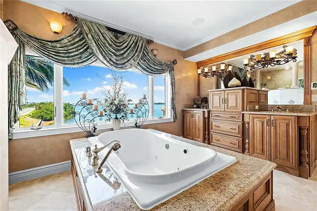 Exterior view of 290 N Washington Dr, a Mediterranean waterfront estate in Sarasota with private dock, saltwater pool, and panoramic bay views