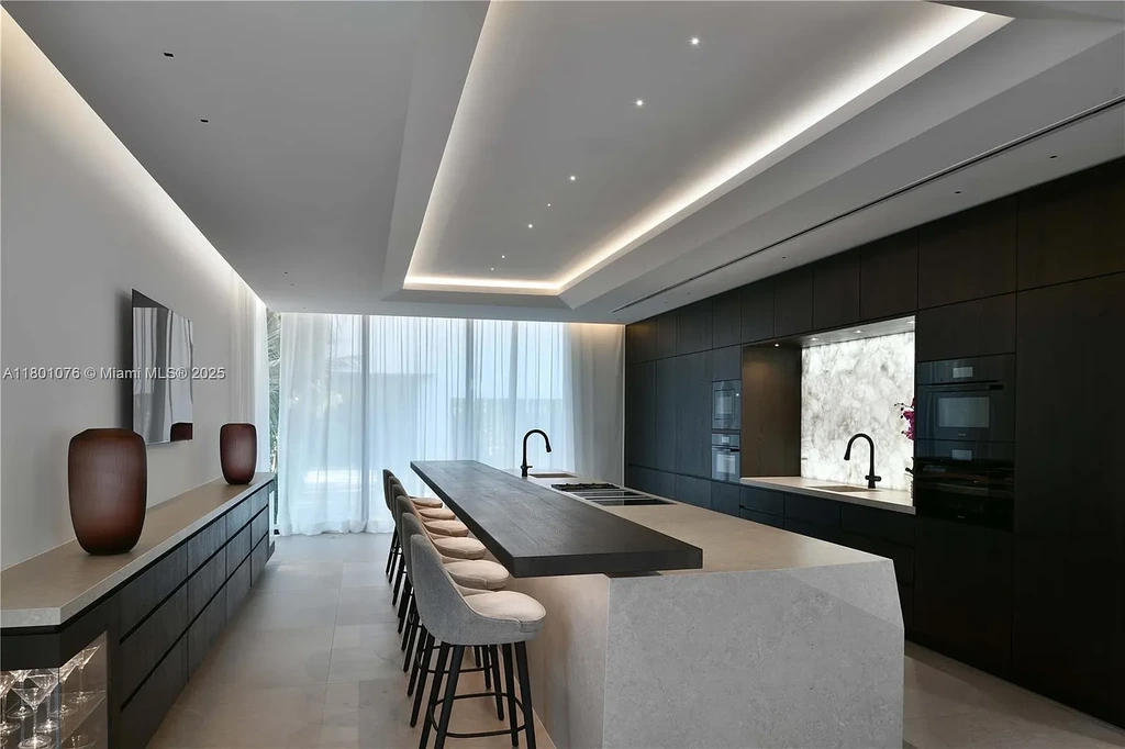 Modern waterfront mansion at 375 N Hibiscus Dr with sleek architecture and bayfront views