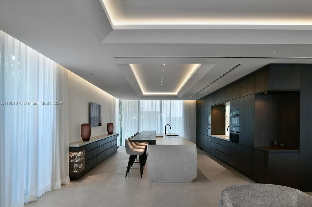 Modern waterfront mansion at 375 N Hibiscus Dr with sleek architecture and bayfront views
