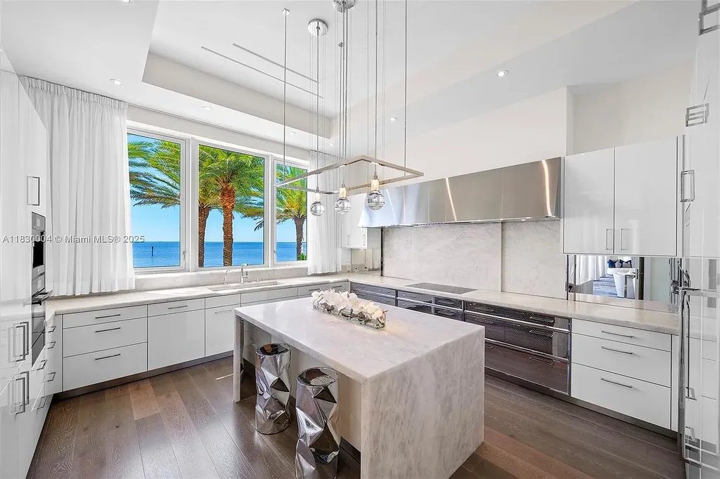 Luxurious primary suite with spa bathroom and bayfront terrace in Coral Gables home for sale
