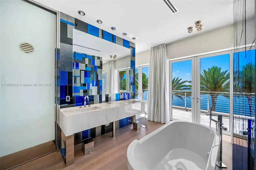Luxurious primary suite with spa bathroom and bayfront terrace in Coral Gables home for sale