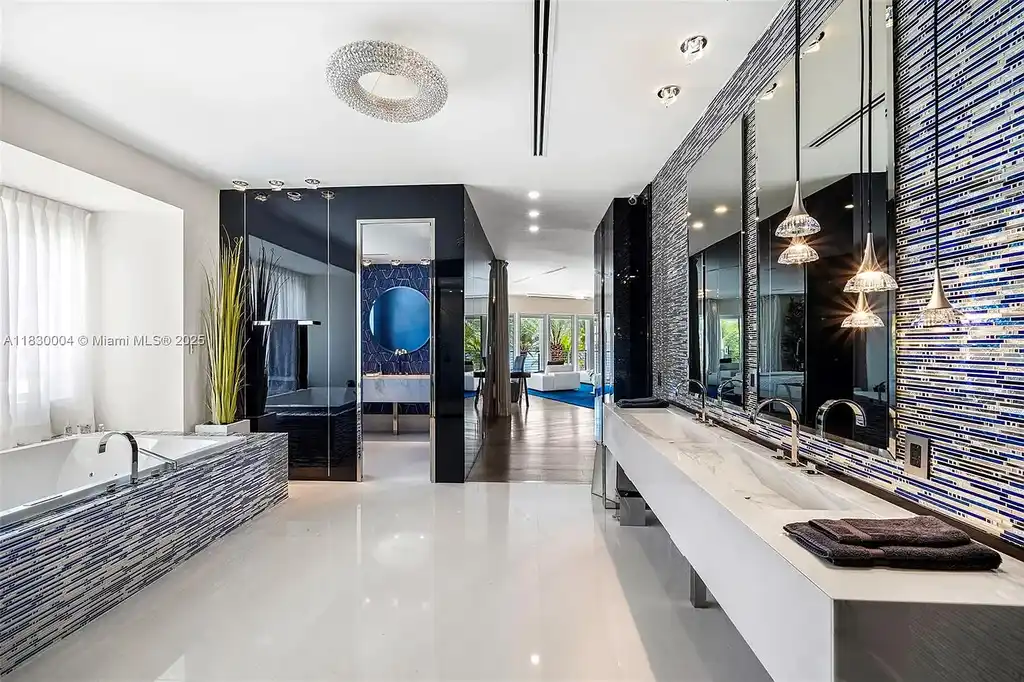 Luxurious primary suite with spa bathroom and bayfront terrace in Coral Gables home for sale