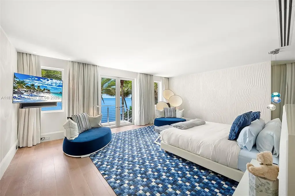 Luxurious primary suite with spa bathroom and bayfront terrace in Coral Gables home for sale