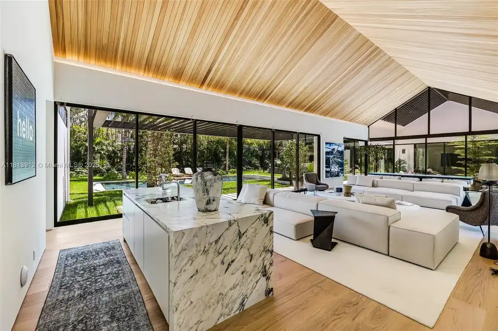 Exterior view of 4820 SW 86th Ter showcasing SAOTA's modern architecture with floor-to-ceiling glass and tropical landscaping.