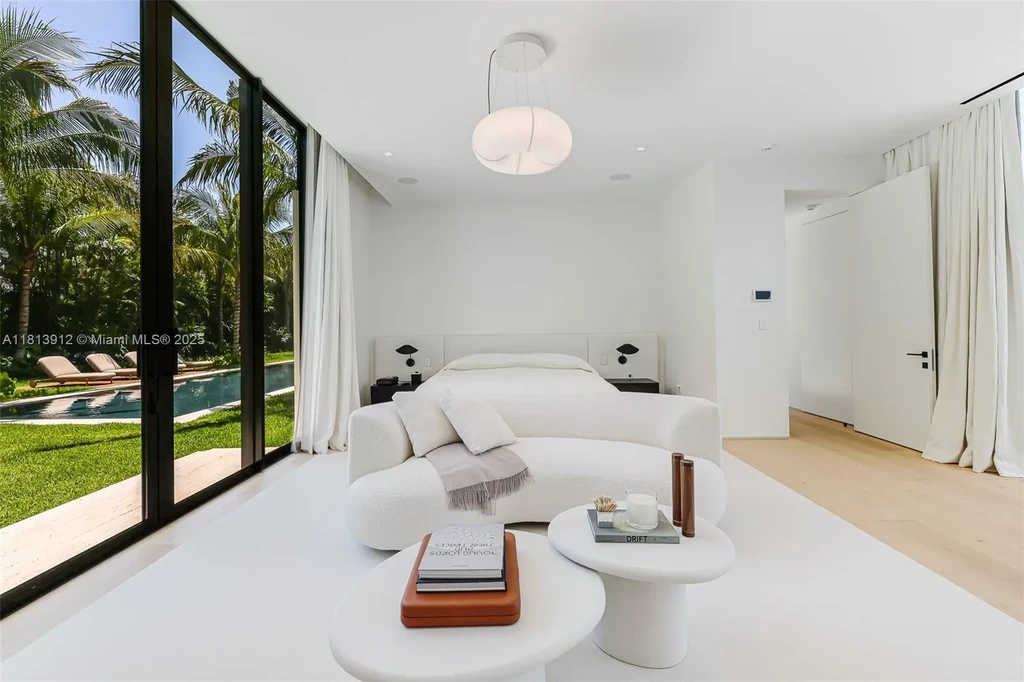 Exterior view of 4820 SW 86th Ter showcasing SAOTA's modern architecture with floor-to-ceiling glass and tropical landscaping.