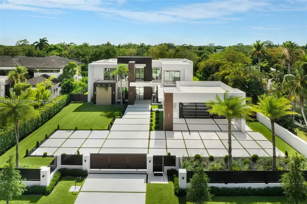 Spacious living room with Italian oak staircase and porcelain floors inside 6900 SW 72nd Ct luxury home in Miami for sale.