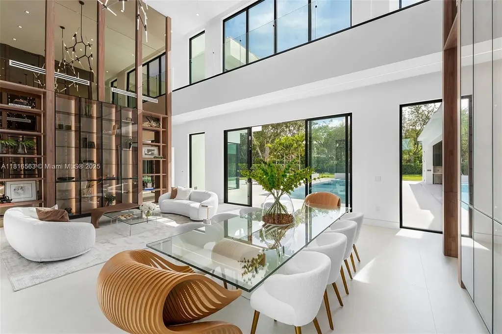 Spacious living room with Italian oak staircase and porcelain floors inside 6900 SW 72nd Ct luxury home in Miami for sale.