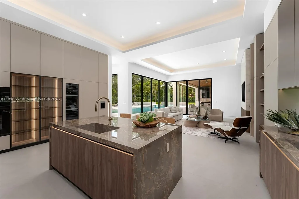 Spacious living room with Italian oak staircase and porcelain floors inside 6900 SW 72nd Ct luxury home in Miami for sale.