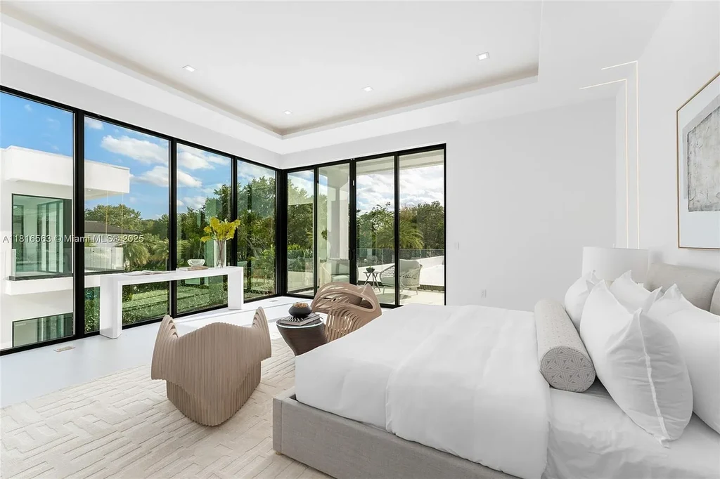 Spacious living room with Italian oak staircase and porcelain floors inside 6900 SW 72nd Ct luxury home in Miami for sale.