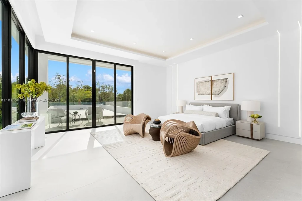 Spacious living room with Italian oak staircase and porcelain floors inside 6900 SW 72nd Ct luxury home in Miami for sale.
