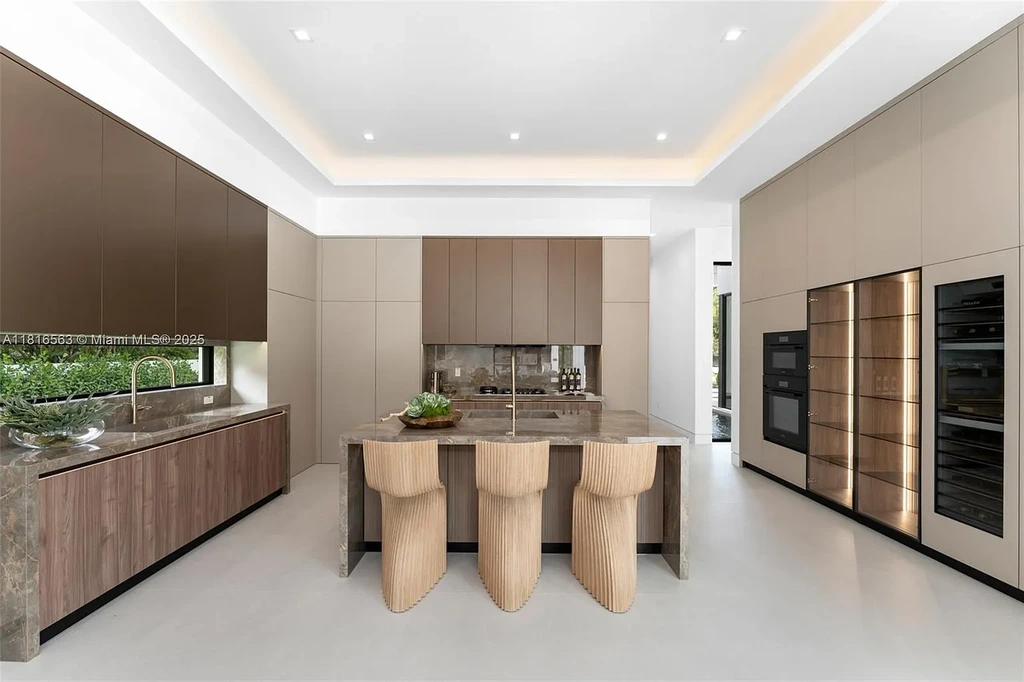 Spacious living room with Italian oak staircase and porcelain floors inside 6900 SW 72nd Ct luxury home in Miami for sale.