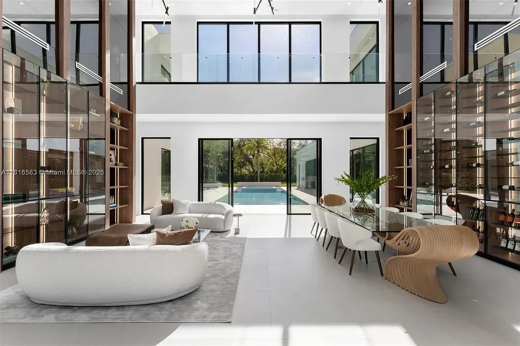 Spacious living room with Italian oak staircase and porcelain floors inside 6900 SW 72nd Ct luxury home in Miami for sale.