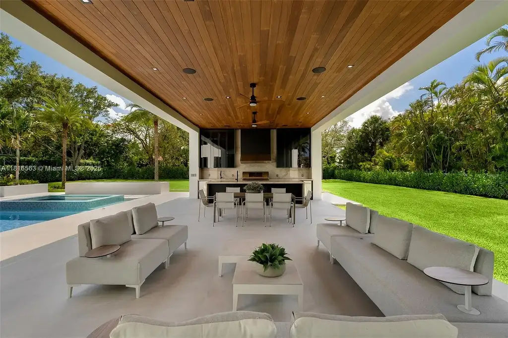 Spacious living room with Italian oak staircase and porcelain floors inside 6900 SW 72nd Ct luxury home in Miami for sale.
