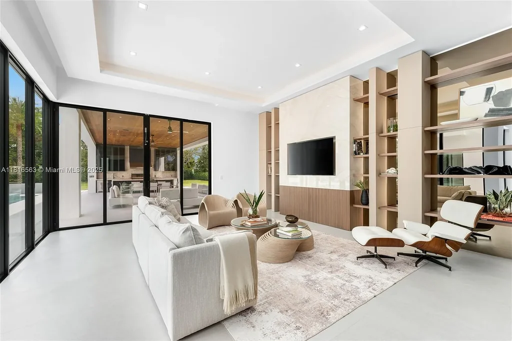 Spacious living room with Italian oak staircase and porcelain floors inside 6900 SW 72nd Ct luxury home in Miami for sale.