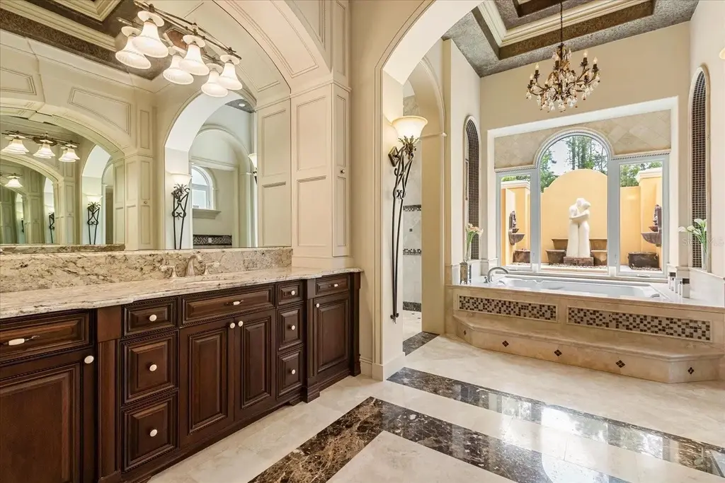 Luxury estate at 8590 Apache Trl in Kissimmee, Florida with Mediterranean design, private gate, and lush 5-acre landscape.