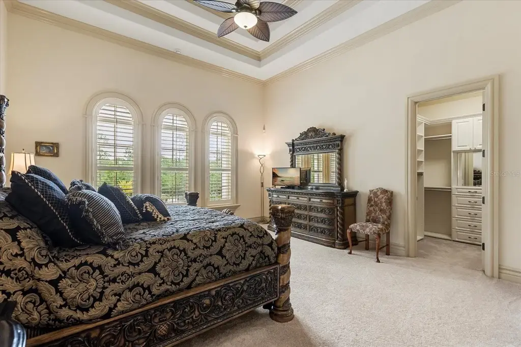 Luxury estate at 8590 Apache Trl in Kissimmee, Florida with Mediterranean design, private gate, and lush 5-acre landscape.