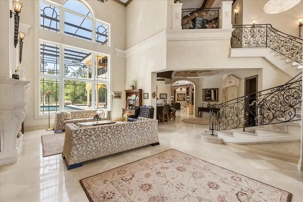 Luxury estate at 8590 Apache Trl in Kissimmee, Florida with Mediterranean design, private gate, and lush 5-acre landscape.