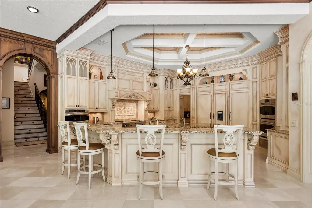 Luxury estate at 8590 Apache Trl in Kissimmee, Florida with Mediterranean design, private gate, and lush 5-acre landscape.