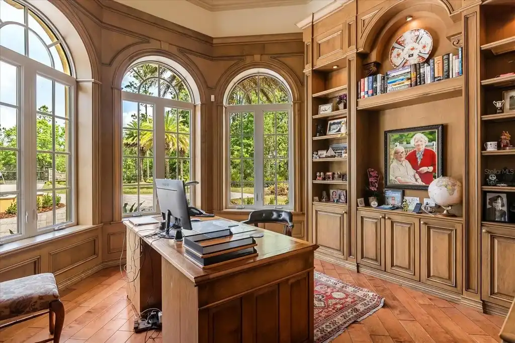 Luxury estate at 8590 Apache Trl in Kissimmee, Florida with Mediterranean design, private gate, and lush 5-acre landscape.