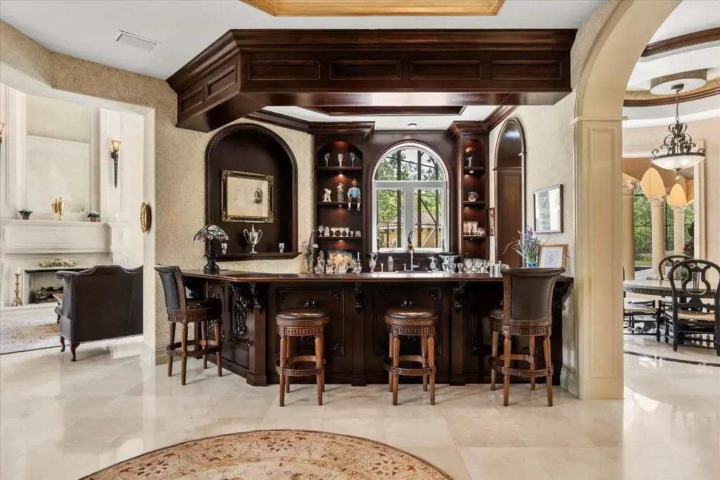Luxury estate at 8590 Apache Trl in Kissimmee, Florida with Mediterranean design, private gate, and lush 5-acre landscape.