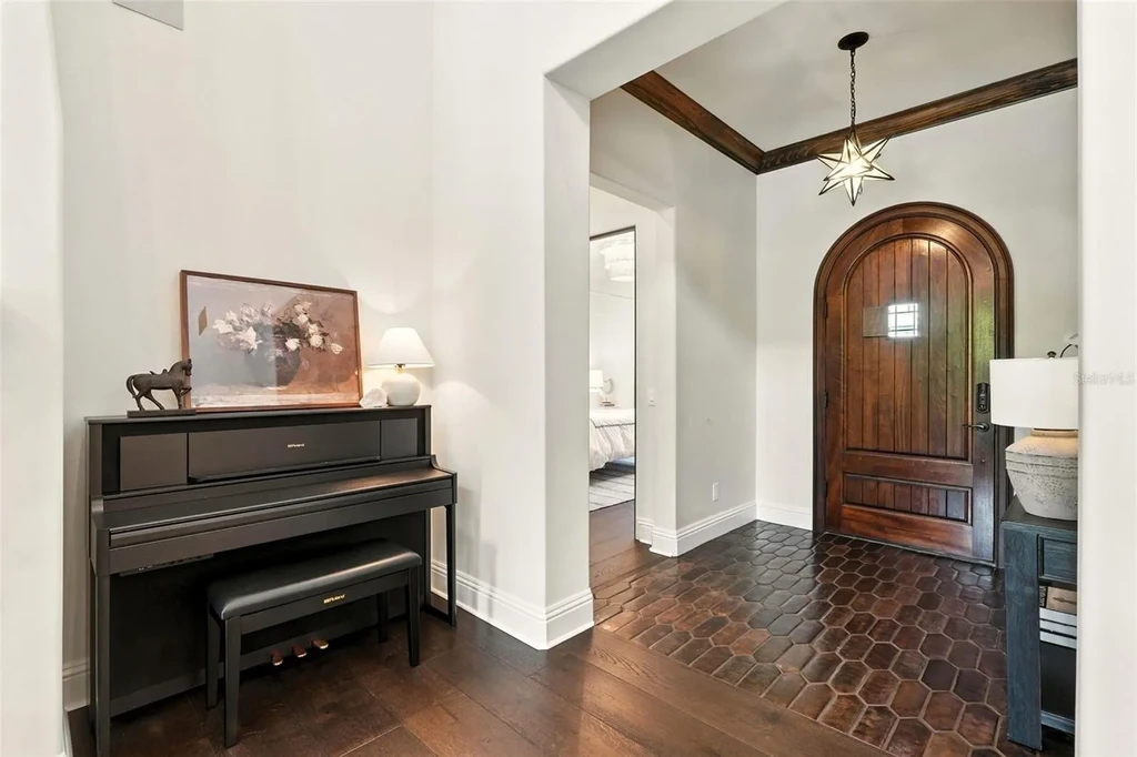 Elegant living room with vaulted ceilings and stone fireplace at 10075 Symphony Grove Dr, Orlando Home for sale