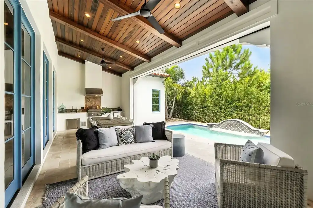 Elegant living room with vaulted ceilings and stone fireplace at 10075 Symphony Grove Dr, Orlando Home for sale