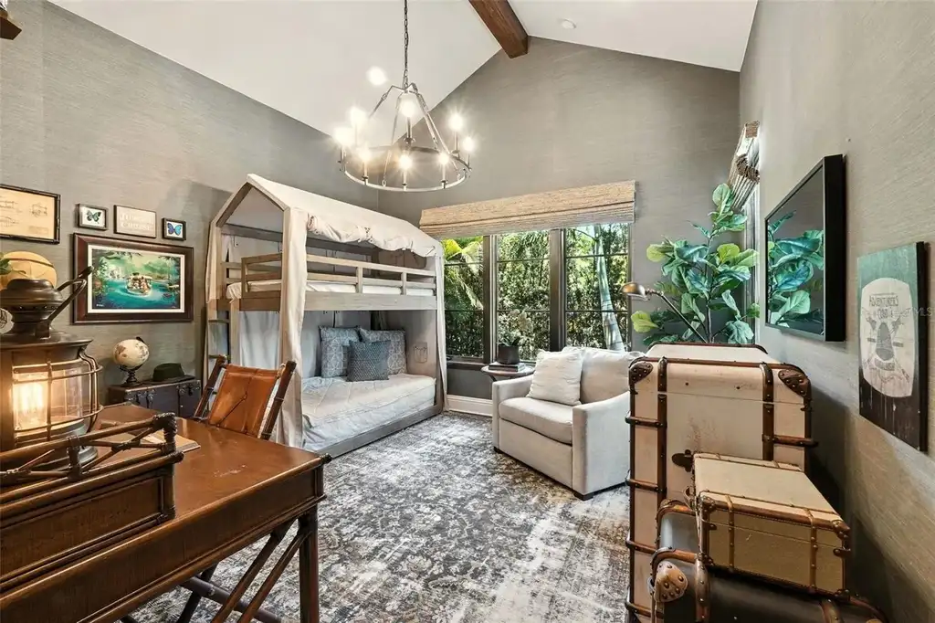 Elegant living room with vaulted ceilings and stone fireplace at 10075 Symphony Grove Dr, Orlando Home for sale