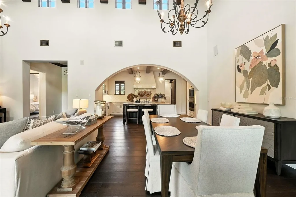 Elegant living room with vaulted ceilings and stone fireplace at 10075 Symphony Grove Dr, Orlando Home for sale