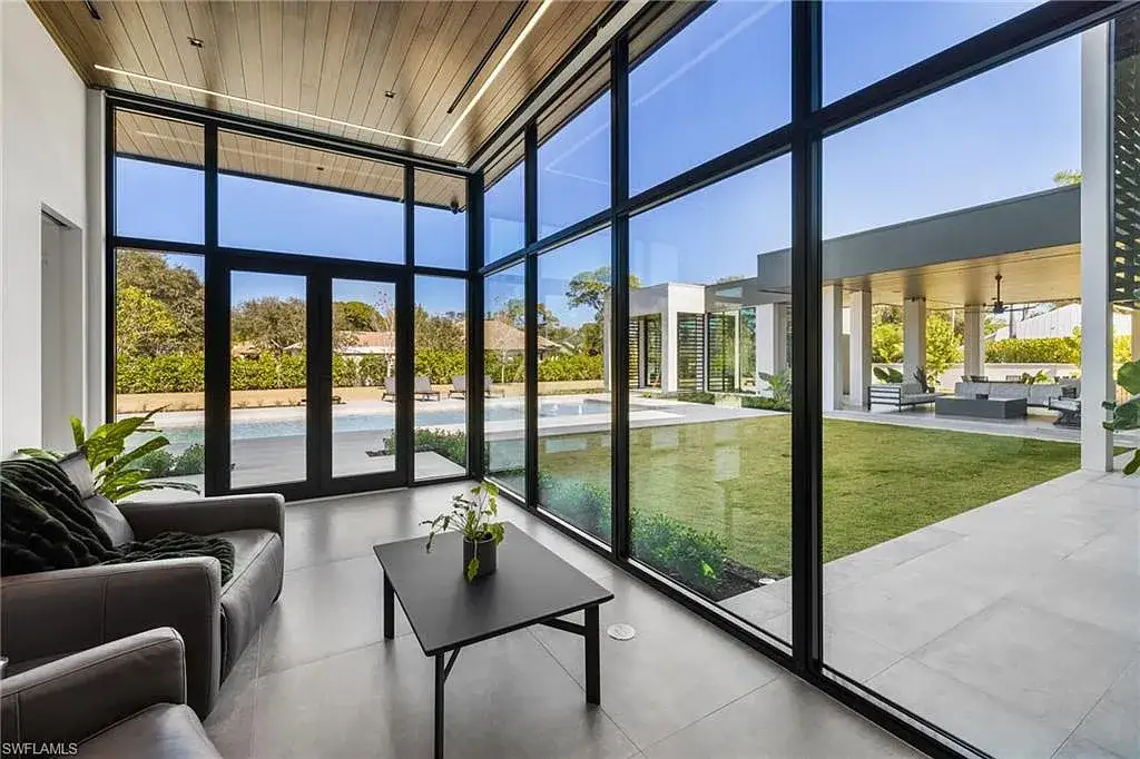 Luxury estate at 107 Myrtle Rd, Naples featuring 5 bedrooms, guest house, lap pool, smart Control4 system, and modern architecture on 1.12-acre lot