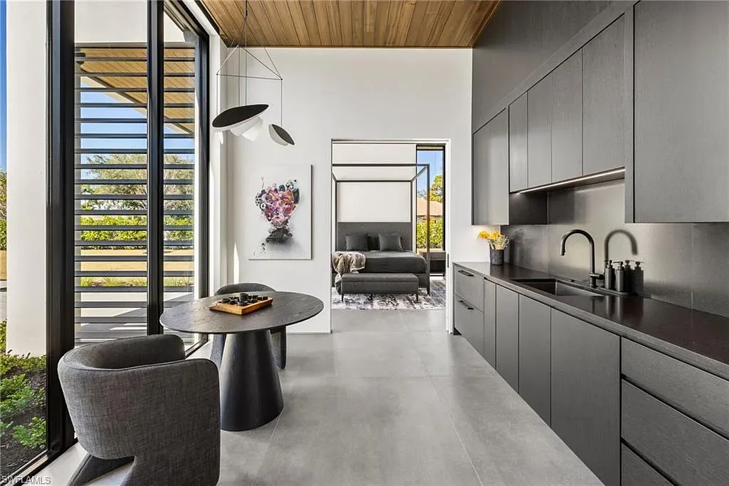 Luxury estate at 107 Myrtle Rd, Naples featuring 5 bedrooms, guest house, lap pool, smart Control4 system, and modern architecture on 1.12-acre lot