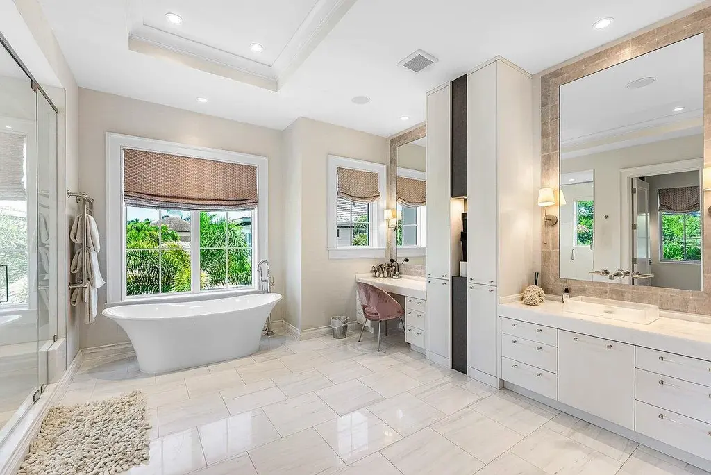 Luxury estate at 1162 Banyan Estates Drive with infinity pool, tropical landscape, and modern design in gated Seminole Landing, North Palm Beach, FL.