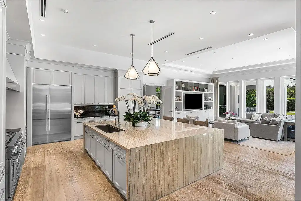 Luxury estate at 1162 Banyan Estates Drive with infinity pool, tropical landscape, and modern design in gated Seminole Landing, North Palm Beach, FL.