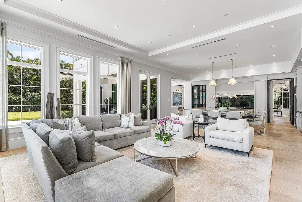 Luxury estate at 1162 Banyan Estates Drive with infinity pool, tropical landscape, and modern design in gated Seminole Landing, North Palm Beach, FL.